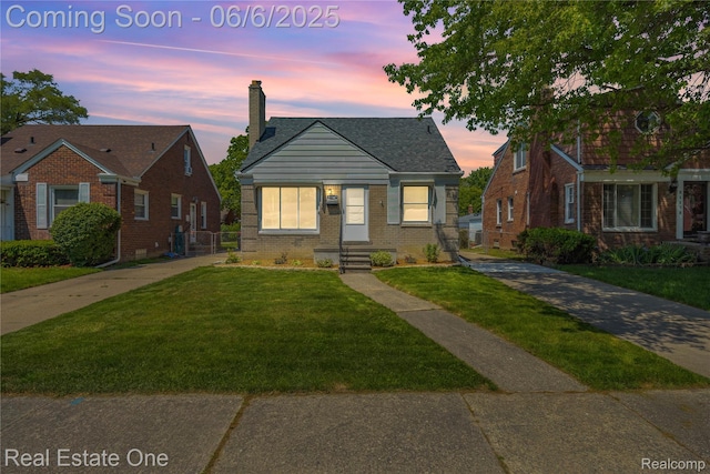 21167 Lancaster St, Grosse Pointe Woods, MI 48225 - bungalow featuring a front yard, brick siding, and a chimney