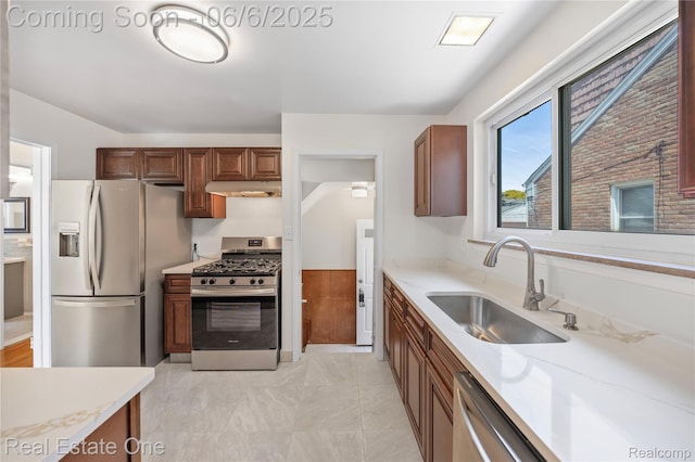 21167 Lancaster St, Grosse Pointe Woods, MI 48225 - kitchen with stainless steel appliances, under cabinet range hood, a sink, and light stone counters