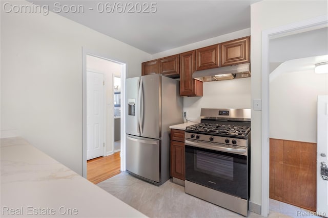 21167 Lancaster St, Grosse Pointe Woods, MI 48225 - kitchen with under cabinet range hood, appliances with stainless steel finishes, and light stone countertops