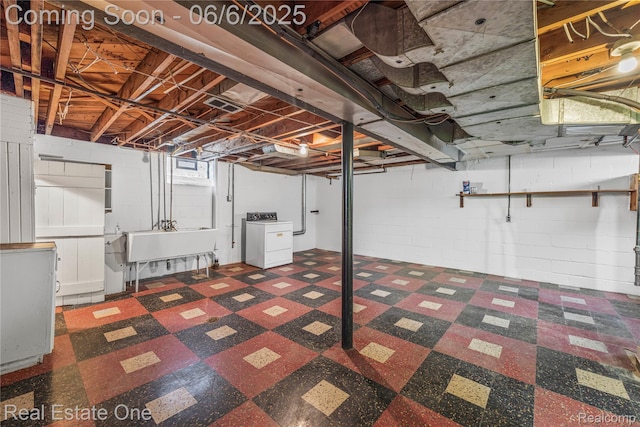 21167 Lancaster St, Grosse Pointe Woods, MI 48225 - below grade area featuring washer / clothes dryer, tile patterned floors, concrete block wall, and a sink