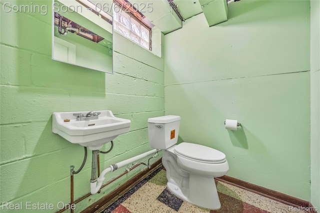 21167 Lancaster St, Grosse Pointe Woods, MI 48225 - bathroom featuring toilet, baseboards, and speckled floor