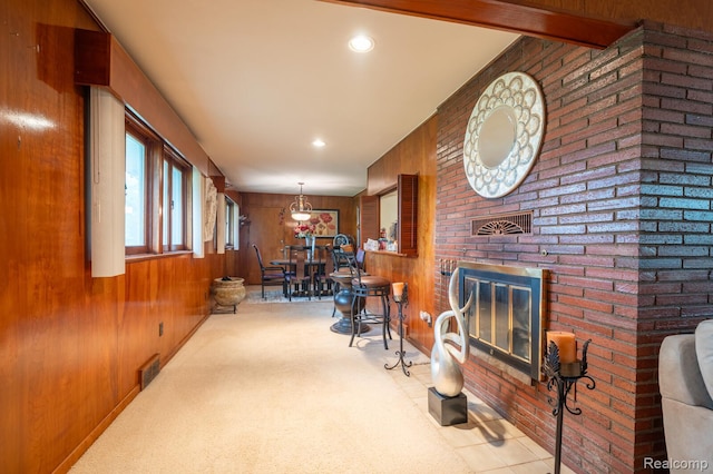 19419 Coral Gables St, Southfield, MI 48076 - sitting room with wood walls, a fireplace, and carpet