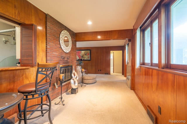 19419 Coral Gables St, Southfield, MI 48076 - sitting room with carpet flooring, wooden walls, healthy amount of natural light, a fireplace, and a dry bar