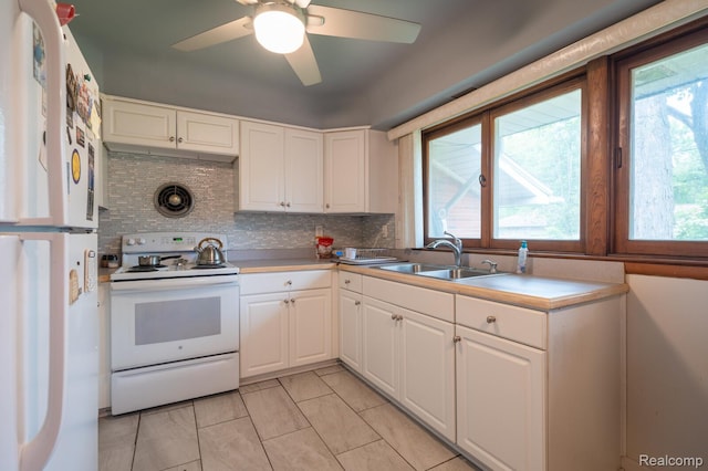 19419 Coral Gables St, Southfield, MI 48076 - kitchen featuring white appliances, a sink, backsplash, and white cabinetry