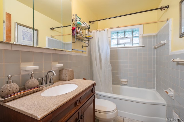 19419 Coral Gables St, Southfield, MI 48076 - full bath with tile walls, toilet, shower / bath combo with shower curtain, vanity, and wainscoting