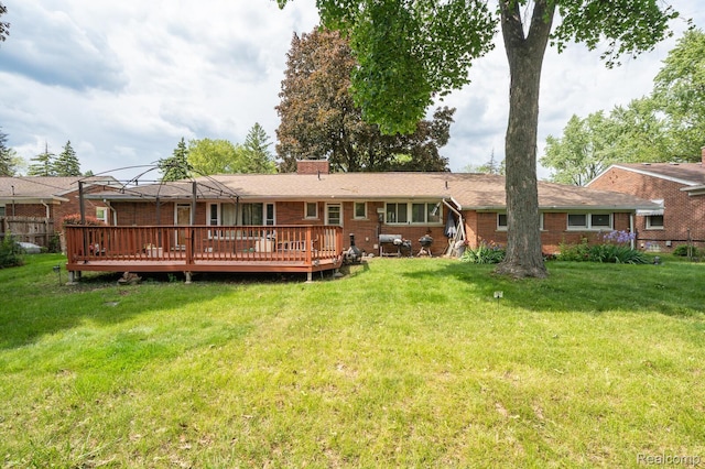 19419 Coral Gables St, Southfield, MI 48076 - back of house with a wooden deck, a chimney, and a yard