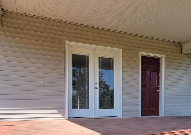 1577 Benner Hwy, Clayton, MI 49235 - property entrance with french doors and a wooden deck