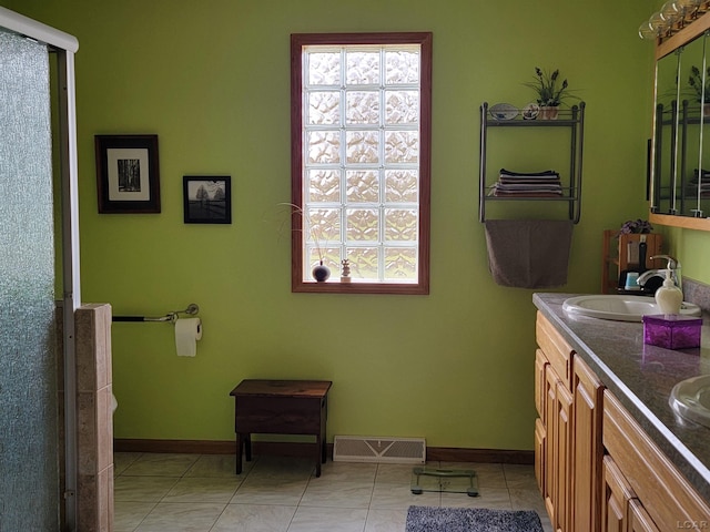 1577 Benner Hwy, Clayton, MI 49235 - bathroom with baseboards, double vanity, a stall shower, and tile patterned floors