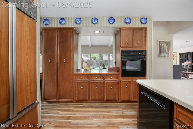 439 Barclay Rd, Grosse Pointe Farms, MI 48236 - kitchen featuring black appliances, light wood finished floors, light countertops, and brown cabinets