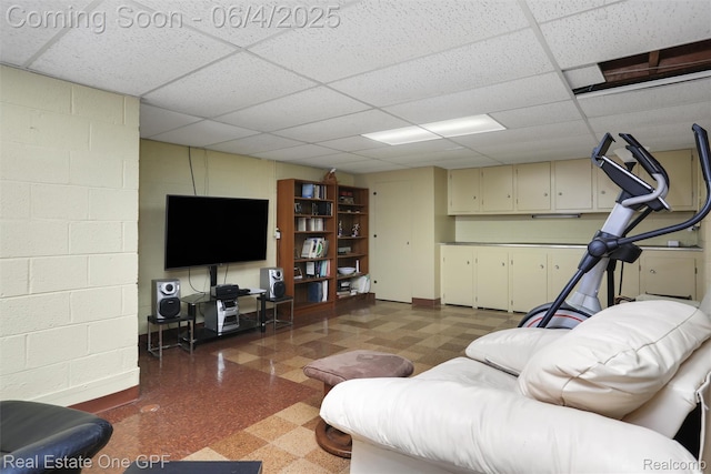 439 Barclay Rd, Grosse Pointe Farms, MI 48236 - living room featuring tile patterned floors, a drop ceiling, and concrete block wall