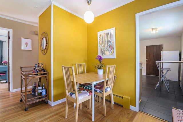 2305 S Circle Dr, Ann Arbor, MI 48103 - dining room featuring wood finished floors, crown molding, and baseboards