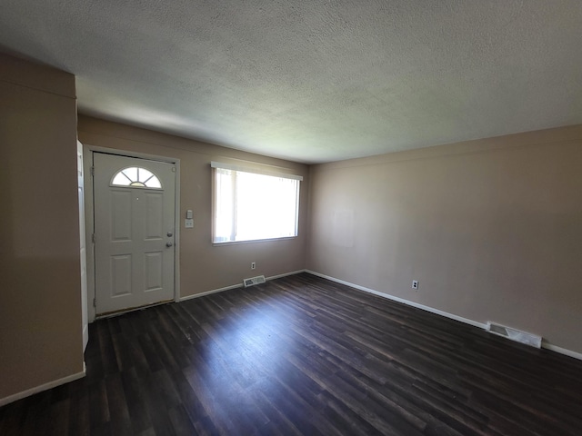 13753 Mcguire St, Taylor, MI 48180 - foyer entrance featuring a textured ceiling, dark wood finished floors, and baseboards