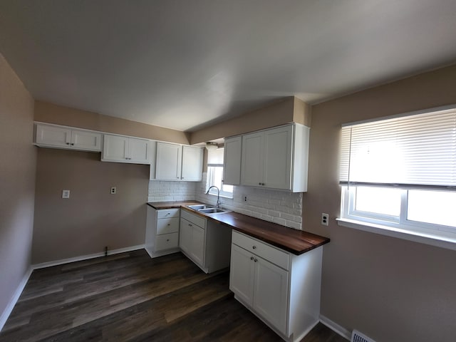 13753 Mcguire St, Taylor, MI 48180 - kitchen featuring a sink, wooden counters, tasteful backsplash, dark wood-style flooring, and white cabinetry