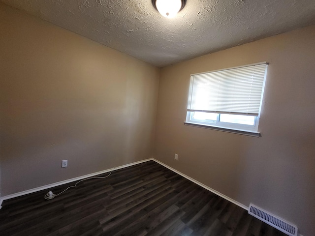 13753 Mcguire St, Taylor, MI 48180 - unfurnished room featuring dark wood finished floors, baseboards, and a textured ceiling
