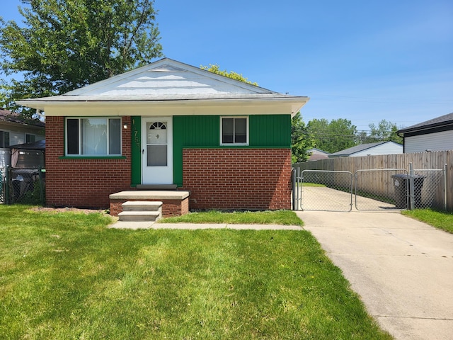 13753 Mcguire St, Taylor, MI 48180 - bungalow-style house featuring brick siding, a gate, and driveway