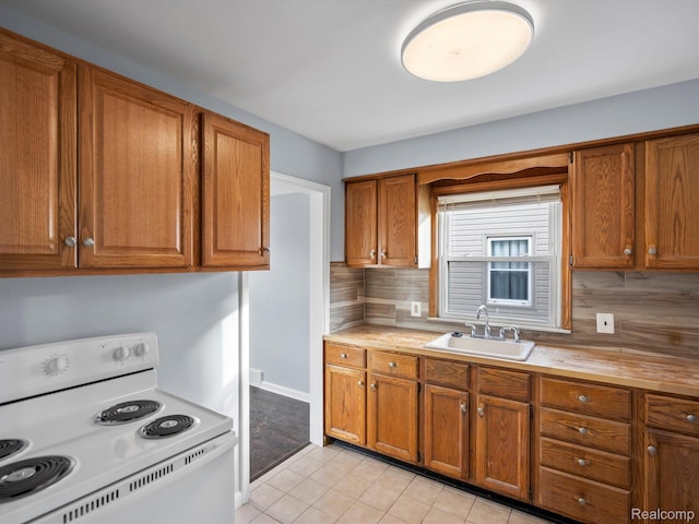 3752 Katherine St, Dearborn, MI 48124 - kitchen with electric range, a sink, and brown cabinetry
