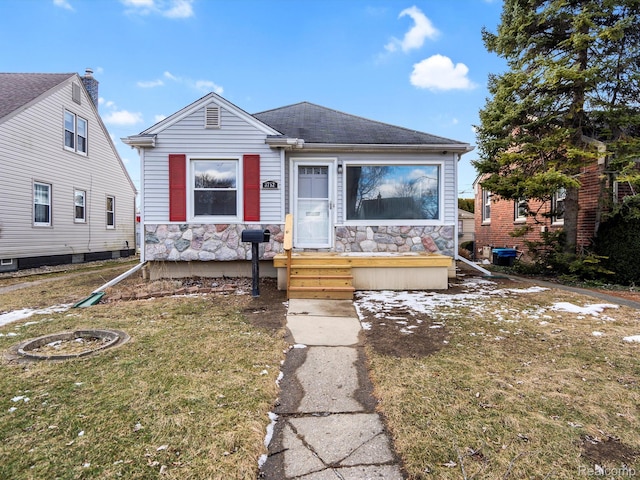 3752 Katherine St, Dearborn, MI 48124 - view of front of house featuring stone siding, a front lawn, and a shingled roof