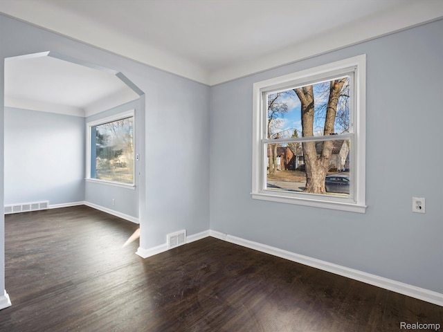 3752 Katherine St, Dearborn, MI 48124 - spare room featuring baseboards, dark wood-style flooring, and arched walkways