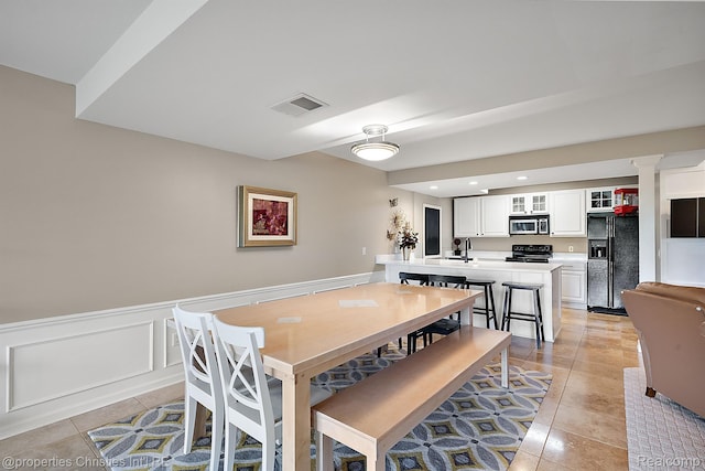 1707 Mountain Ash Dr, West Bloomfield, MI 48324 - dining area featuring light tile patterned floors, a wainscoted wall, and recessed lighting