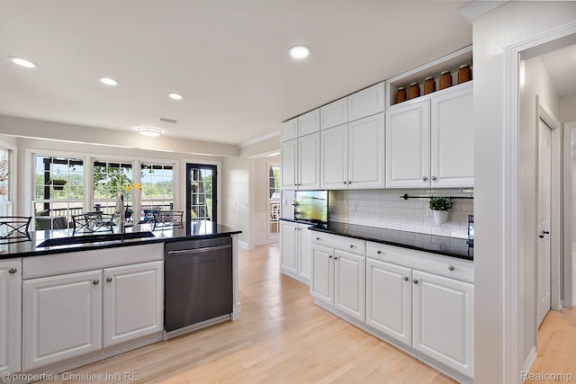 1707 Mountain Ash Dr, West Bloomfield, MI 48324 - kitchen featuring dishwasher, a sink, light wood-type flooring, dark countertops, and white cabinetry