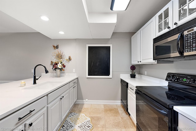 1707 Mountain Ash Dr, West Bloomfield, MI 48324 - kitchen with black appliances, a sink, baseboards, white cabinets, and light countertops