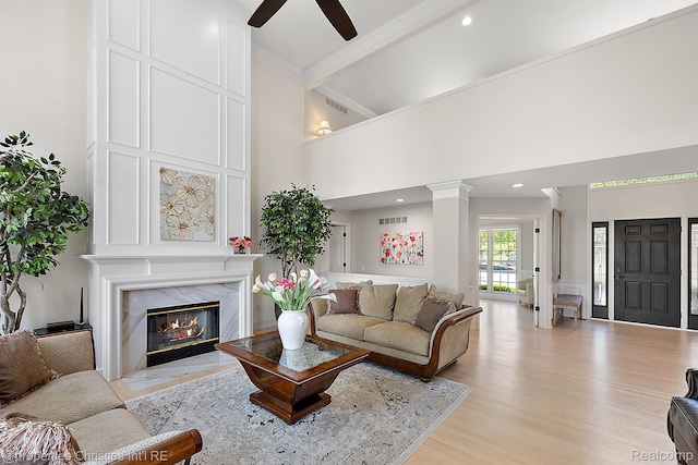 1707 Mountain Ash Dr, West Bloomfield, MI 48324 - living room with ceiling fan, light wood finished floors, a towering ceiling, a fireplace, and beamed ceiling