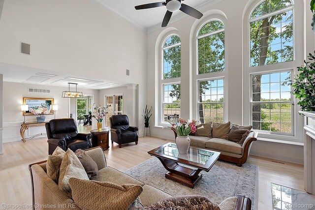 1707 Mountain Ash Dr, West Bloomfield, MI 48324 - living area with plenty of natural light, light wood finished floors, ornamental molding, high vaulted ceiling, and a ceiling fan