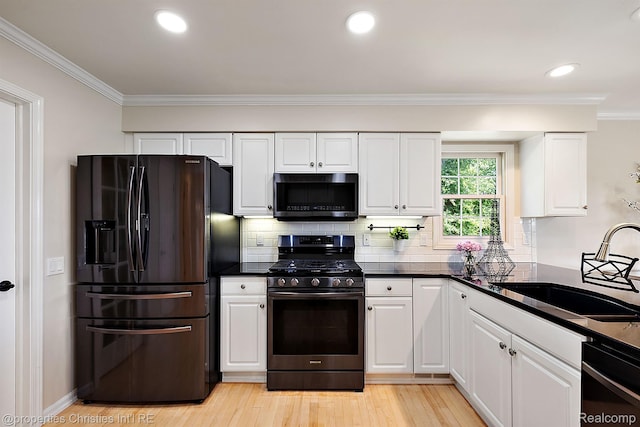 1707 Mountain Ash Dr, West Bloomfield, MI 48324 - kitchen featuring black appliances, a sink, crown molding, white cabinets, and dark countertops