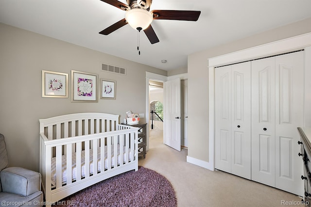 1707 Mountain Ash Dr, West Bloomfield, MI 48324 - bedroom with light colored carpet, a closet, a nursery area, and ceiling fan
