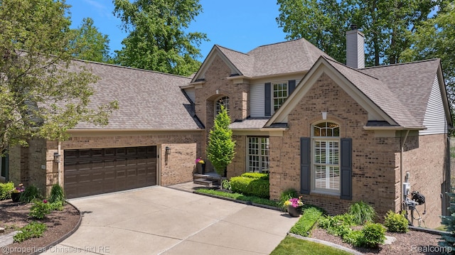 1707 Mountain Ash Dr, West Bloomfield, MI 48324 - traditional-style house featuring brick siding, driveway, roof with shingles, a chimney, and a garage