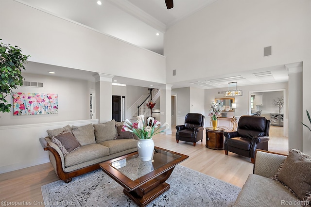 1707 Mountain Ash Dr, West Bloomfield, MI 48324 - living room featuring ornate columns, light wood-style floors, a high ceiling, baseboards, and recessed lighting