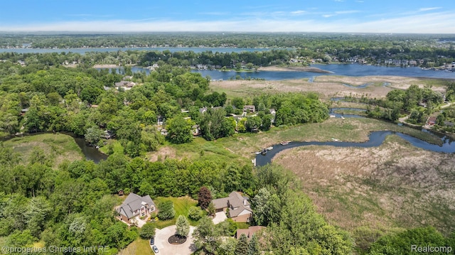 1707 Mountain Ash Dr, West Bloomfield, MI 48324 - aerial overview of property's location with a large body of water and a heavily wooded area