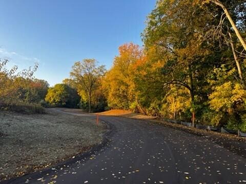 surrounding community featuring a wooded view