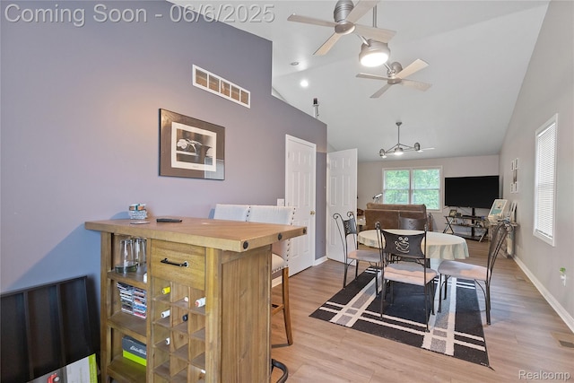 39650 Macomber St, Harrison Township, MI 48045 - dining space featuring a ceiling fan, wood finished floors, baseboards, and high vaulted ceiling