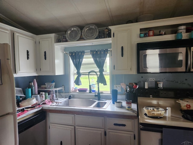 1610 Sunburst St, Grawn, MI 49637 - kitchen with appliances with stainless steel finishes and white cabinets