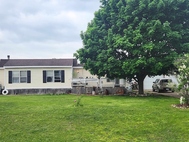 1610 Sunburst St, Grawn, MI 49637 - view of front of home featuring a front yard and a garage