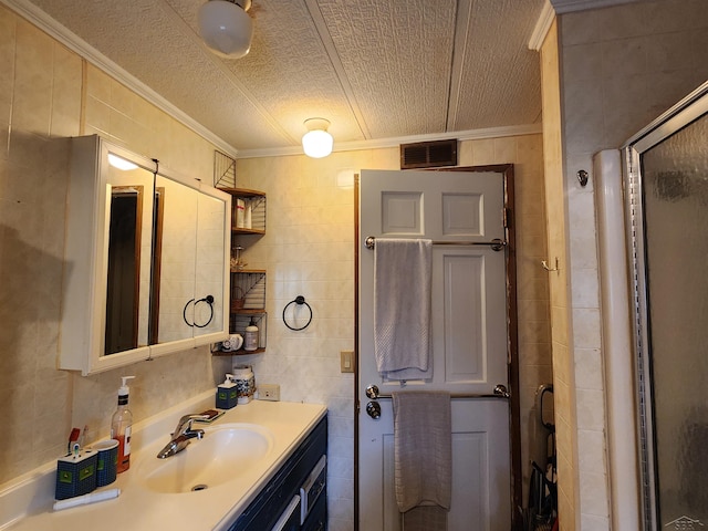 1610 Sunburst St, Grawn, MI 49637 - bathroom with ornamental molding, vanity, a stall shower, tile walls, and a textured ceiling