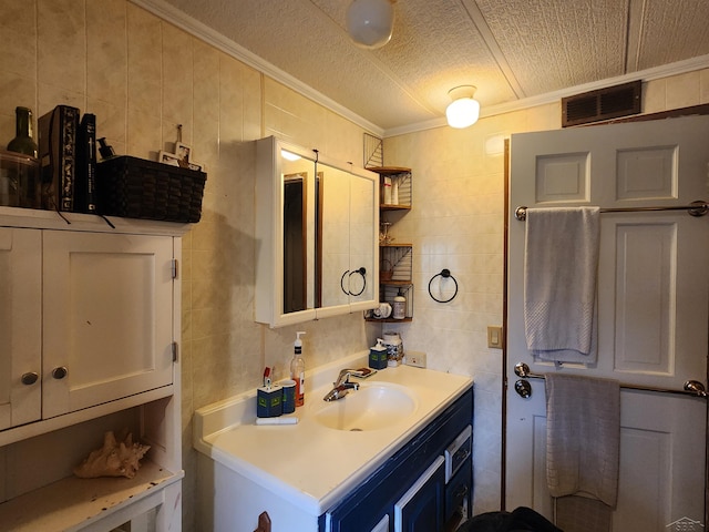 1610 Sunburst St, Grawn, MI 49637 - bathroom with ornamental molding, vanity, a textured ceiling, and tile walls