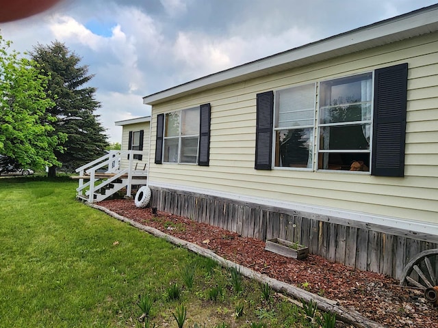 1610 Sunburst St, Grawn, MI 49637 - view of property exterior featuring a lawn