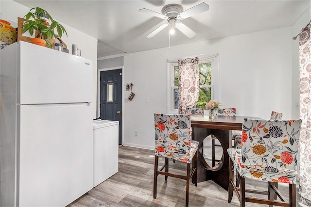 236 Mary St, Plainwell, MI 49080 - dining room featuring wood finished floors, ceiling fan, baseboards, and washer / clothes dryer