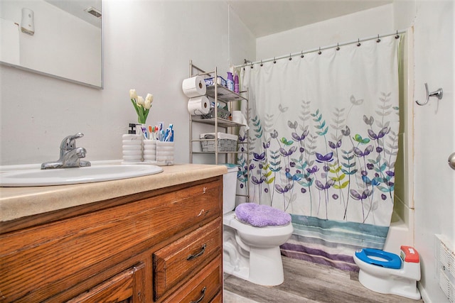 236 Mary St, Plainwell, MI 49080 - full bathroom with toilet, vanity, wood finished floors, and shower / bathtub combination with curtain