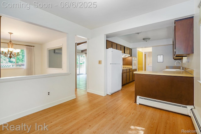11641 Juniper Dr, Van Buren, MI 48111 - kitchen featuring white appliances, a sink, light wood finished floors, and plenty of natural light