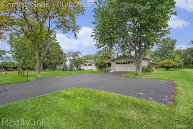 11641 Juniper Dr, Van Buren, MI 48111 - view of front facade with a front lawn, asphalt driveway, and a garage