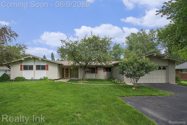 11641 Juniper Dr, Van Buren, MI 48111 - view of front of house with brick siding, an attached garage, a front lawn, and asphalt driveway
