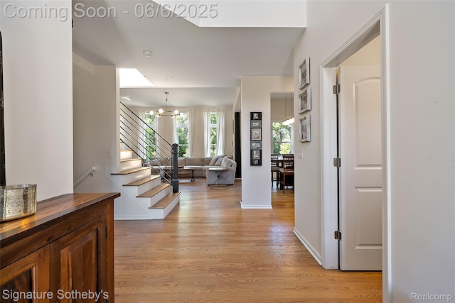 871 Wynstone Cir S, Oakland, MI 48363 - foyer featuring a chandelier, light wood-style flooring, stairs, and baseboards