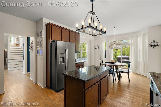 871 Wynstone Cir S, Oakland, MI 48363 - kitchen with stainless steel fridge, dark stone counters, light wood-style floors, and a center island