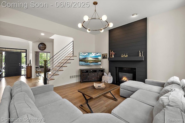871 Wynstone Cir S, Oakland, MI 48363 - living room with a chandelier, stairs, wood finished floors, healthy amount of natural light, and recessed lighting