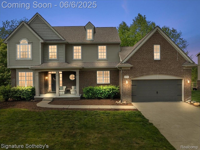 871 Wynstone Cir S, Oakland, MI 48363 - view of front facade featuring covered porch, concrete driveway, brick siding, a garage, and a front yard