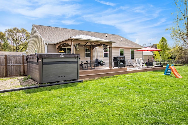 69698 Fox Xing, Edwardsburg, MI 49112 - rear view of property with a gazebo, a hot tub, a deck, and a shingled roof