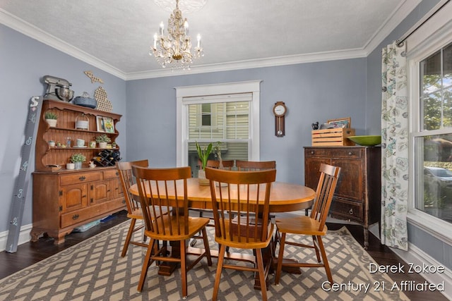 1237 Wealthy St SE, Grand Rapids, MI 49506 - dining area featuring wood finished floors, a chandelier, baseboards, and crown molding